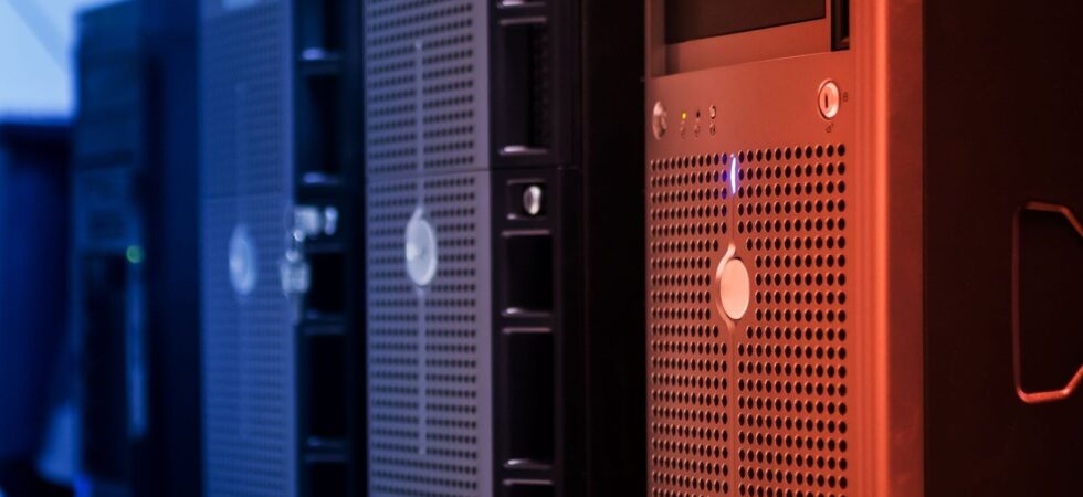 Close-up of blue and orange server racks with ventilation grilles